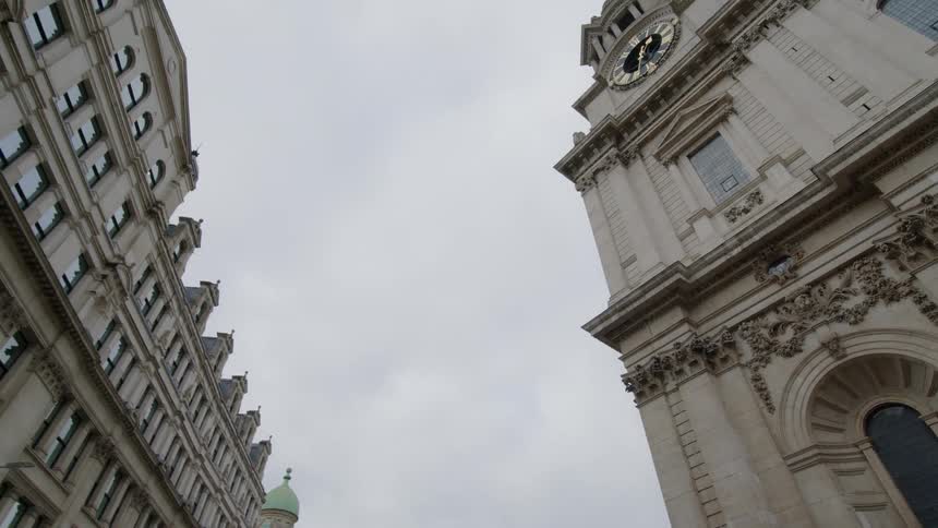 A shot from the bottom of an architectural building and the roof of buildings