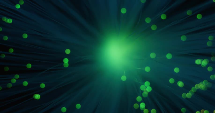 Orbs rotate around a glowing red flare emitting light rays as the color changes to green