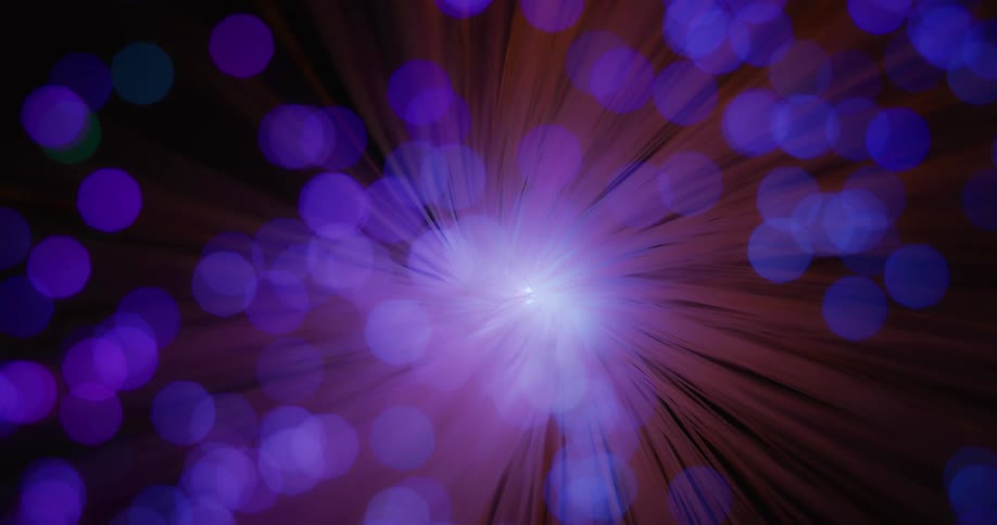 Pink lines flare in the darkness as purple orbs rotate as they glow