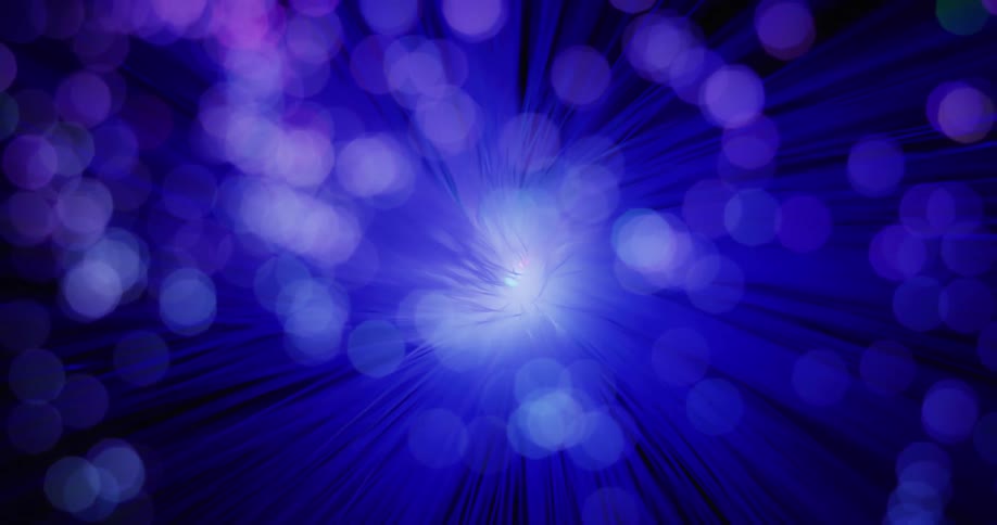 Purple lines and unfocused motes circle a central light
