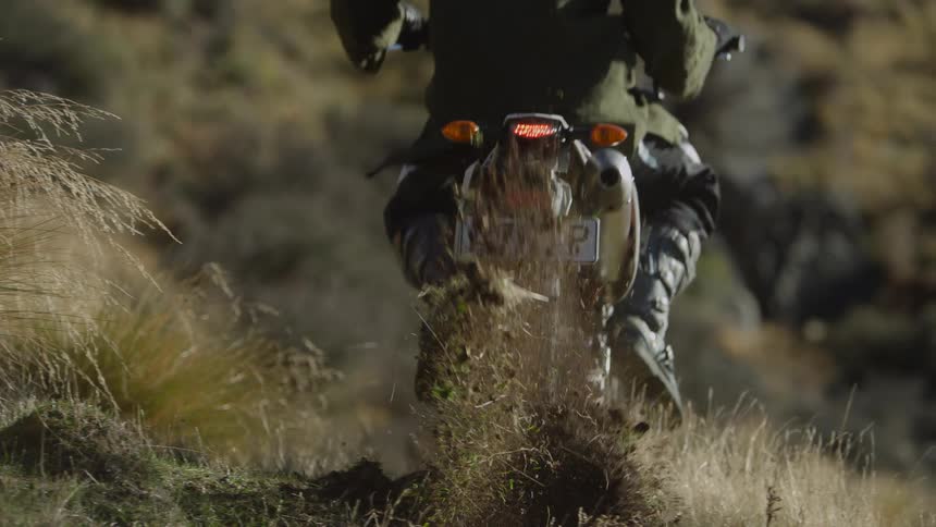A person shoots dirt behind them when passing with their dirt bike