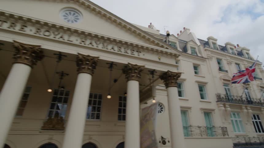 British flags fly outside of the historic royal haymarket theater building in london