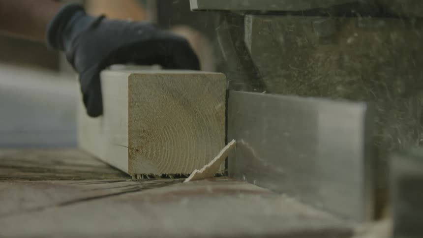 The view is of a working sawing some wood