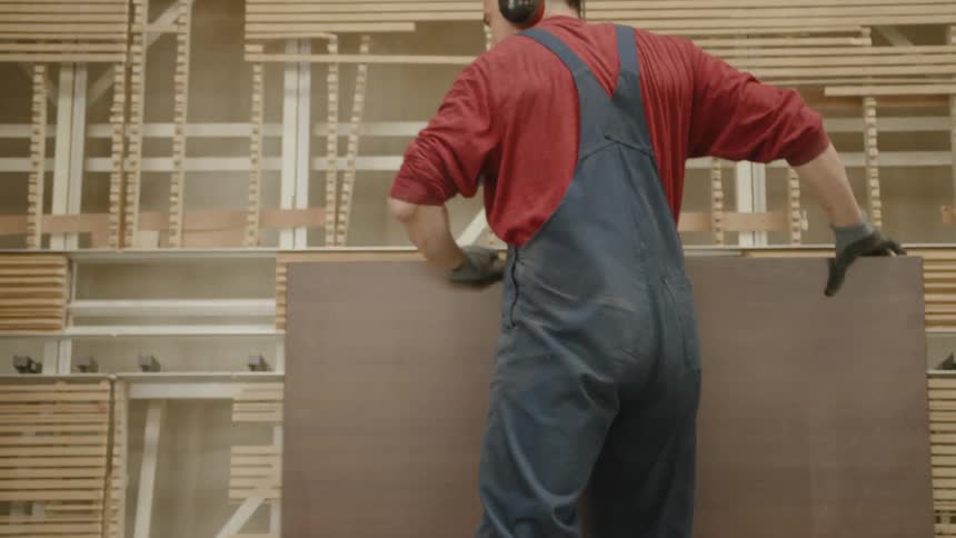 A man loads wood into a machine
