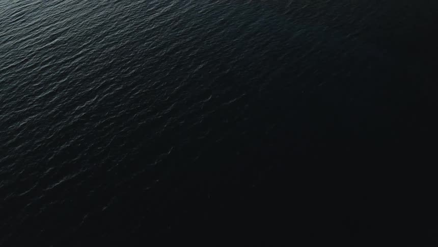 Aerial view of waves in the ocean water is displayed