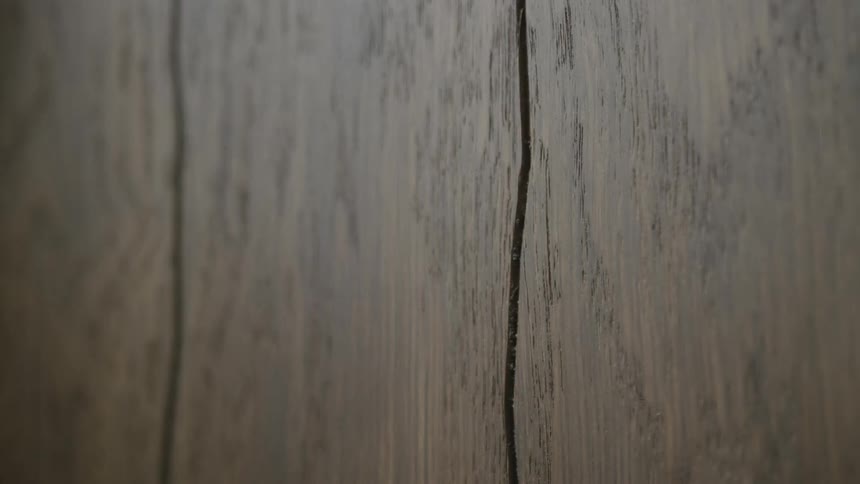 Textured wooden panels cover wall