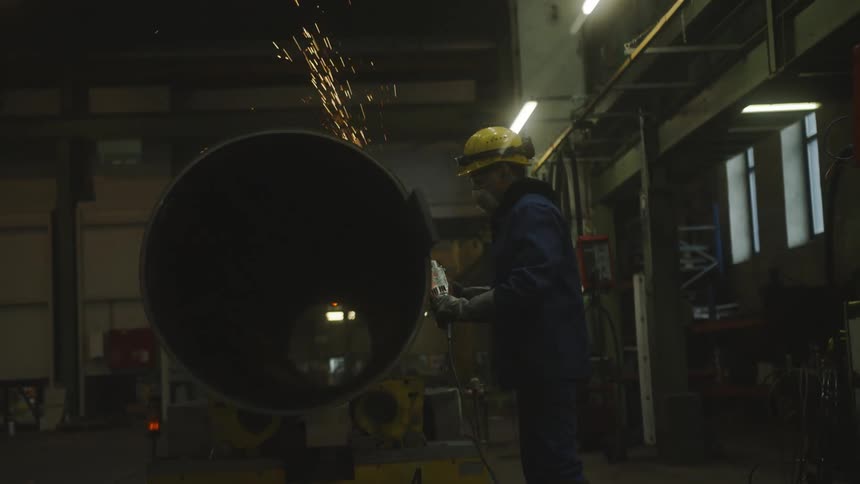 A working is working in a factory inside around day time