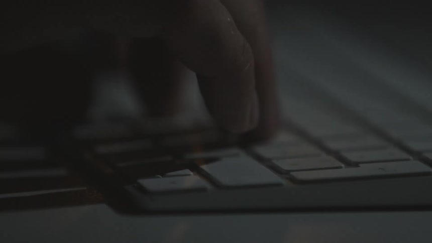 A person is typing on the keyboard