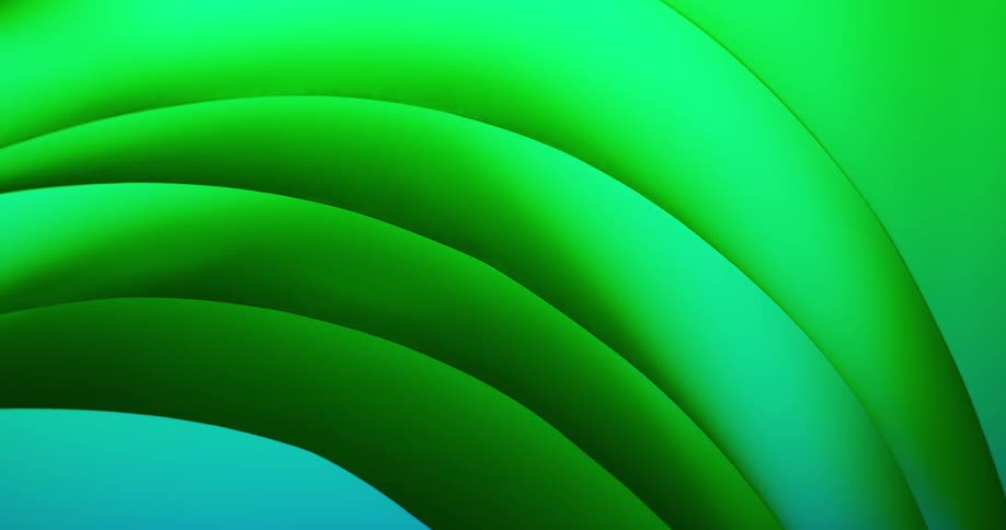Aqua colored light shines on a shiny rounded green object as it slowly moves