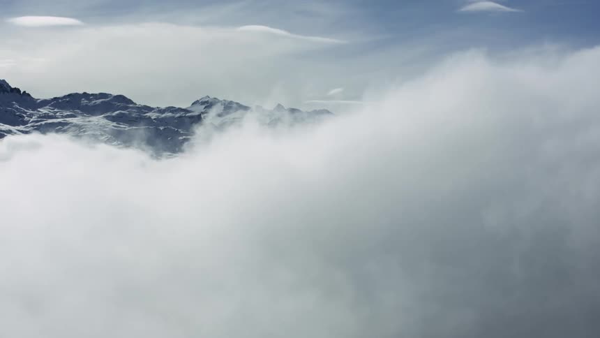 Aerial Serenity: Clouds and Snowy St. Moritz Peaks