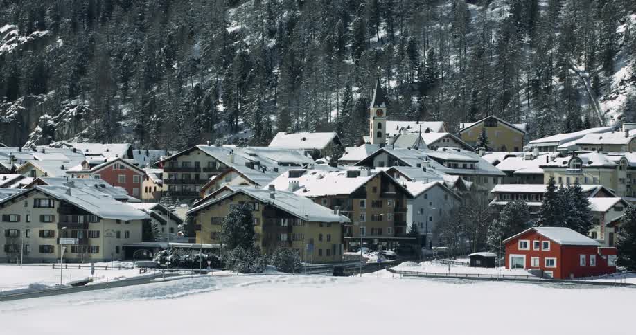 Aerial View: Snowy Town near St. Moritz Mountain