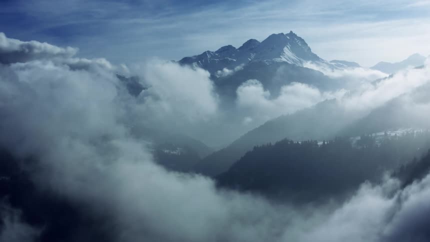 Mystical Beauty: Rolling Clouds over St. Moritz Mountains