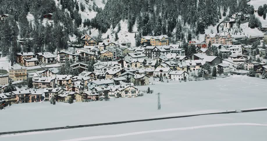 Aerial View of Snow-Covered Village by the Mountains