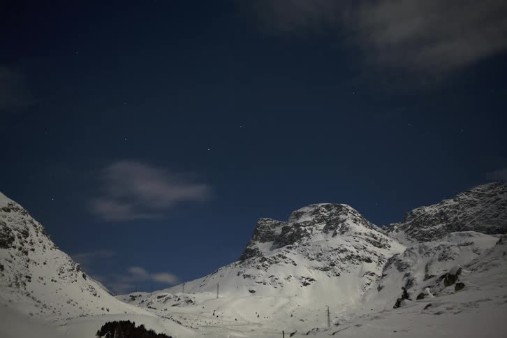 Majestic Mountain Time-Lapse: Moving Clouds Over Snowy Peaks