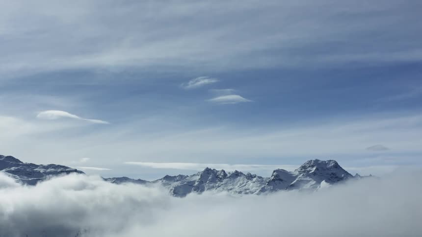 Majestic Aerial: Clouds Over Snowy St. Moritz Valley