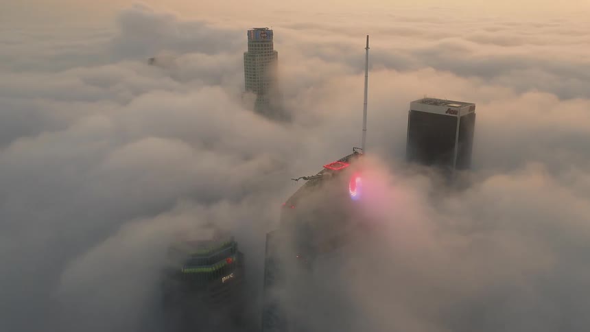 Time lapse of skyscrapers covered in dense fog