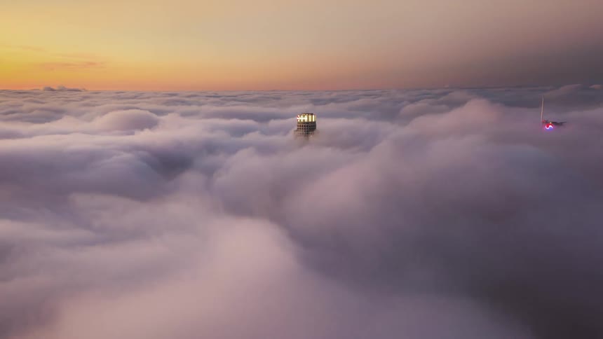 Aerial view of skyscrapers covered in fog