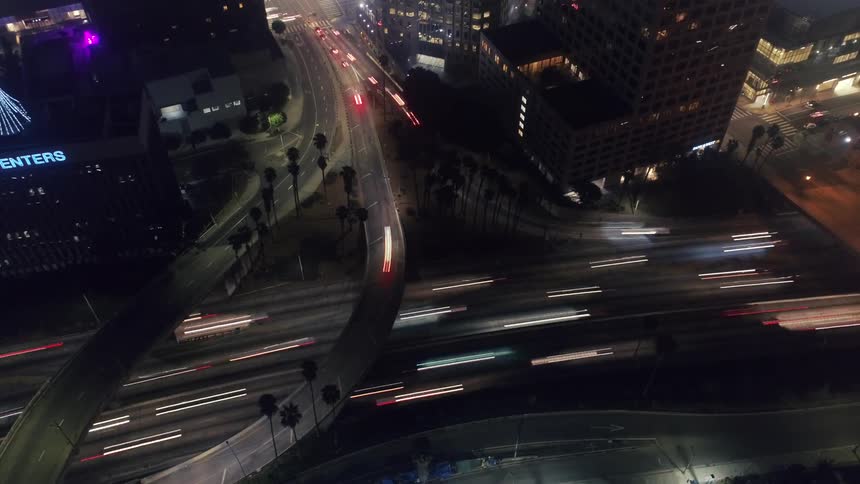 Time lapse of vehicles driving on highways in downtown area at night