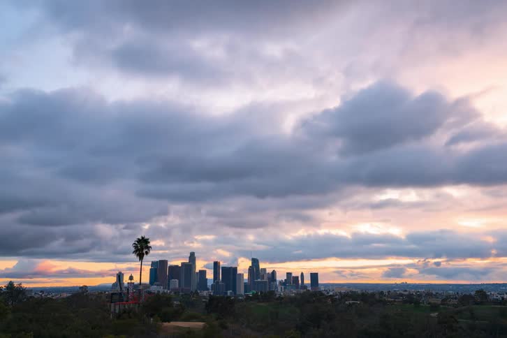A time lapse of a city skyline from mid day dusk to night