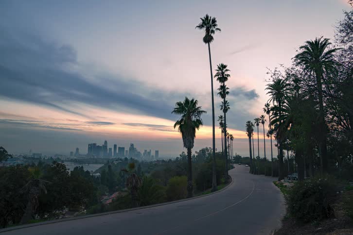 Cars drive towards the city