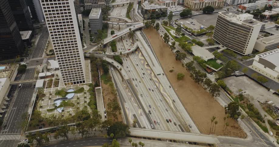 The view is of the downtown area and cars are driving on the highway