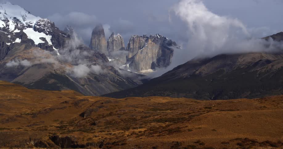 Snow covers the peaks of talls mountains