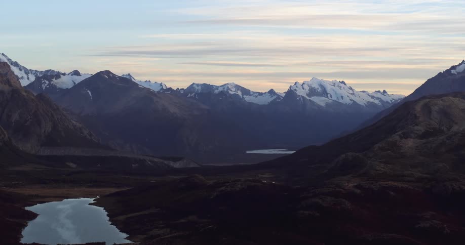 Snow covers the peaks of a vast mountain range
