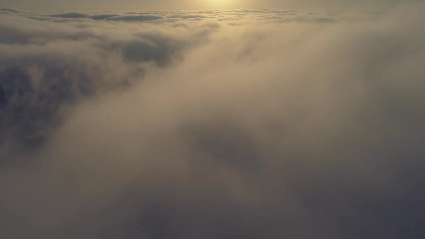 Aerial view of a cloudy sky is displayed at dusk