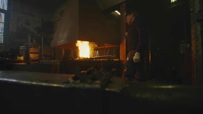 An older white man is standing inside of a house