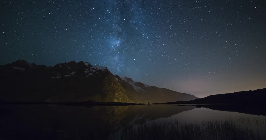 A beautiful starry night sky is seen above a mountain range in this time lapse