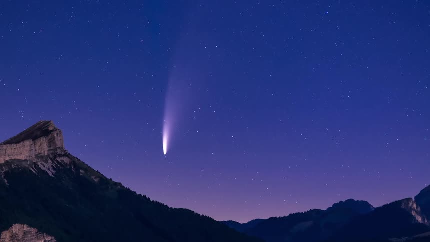 A time lapse of a starry sky filling the night as it moves across the sky with the silhouette of mountains in the forefront