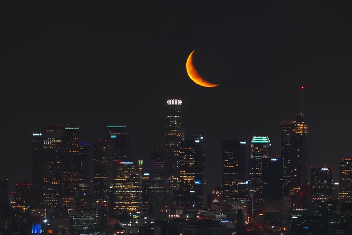 Aerial view of the moon over Los Angeles during the night time
