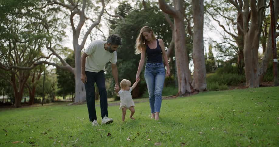 Parents walk their child in the park