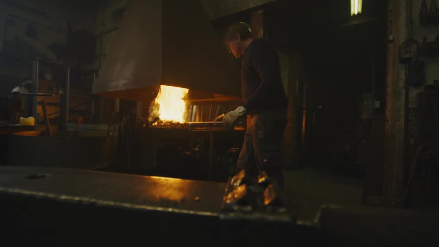A man is inside of his home and is cooking food