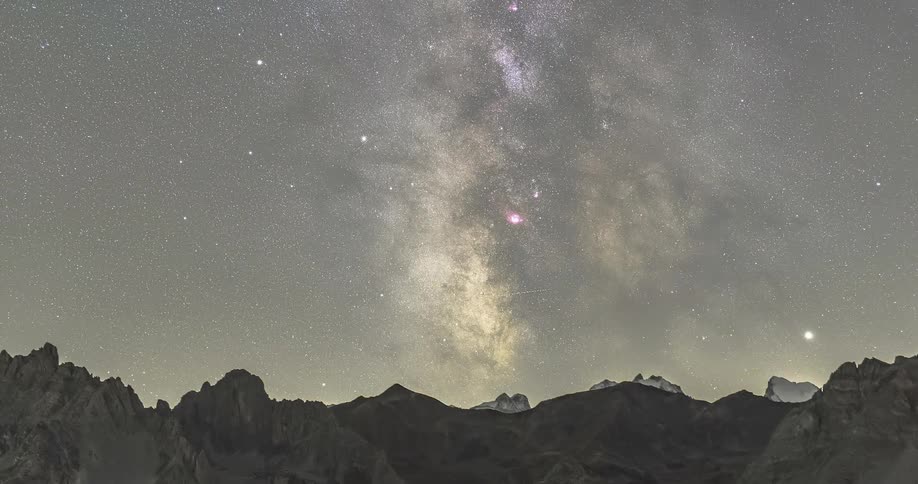 Time lapse of a starry sky moving over the mountains at night