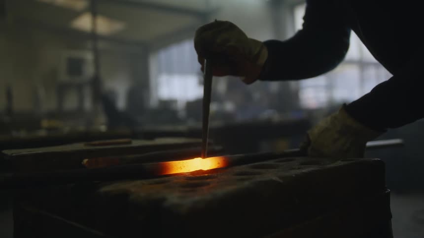 A man is working inside of a factory in the day time