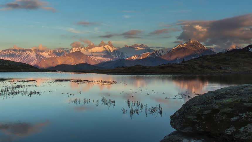 A lake sits by the mountains