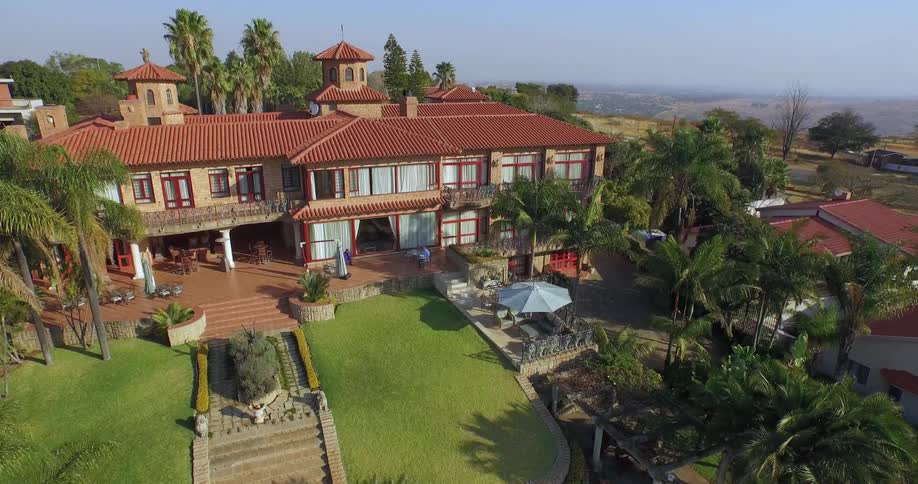 A large house surrounded by palm trees