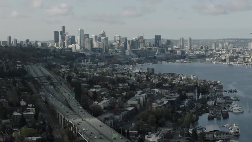 The city is full of buildings and vehicles traveling