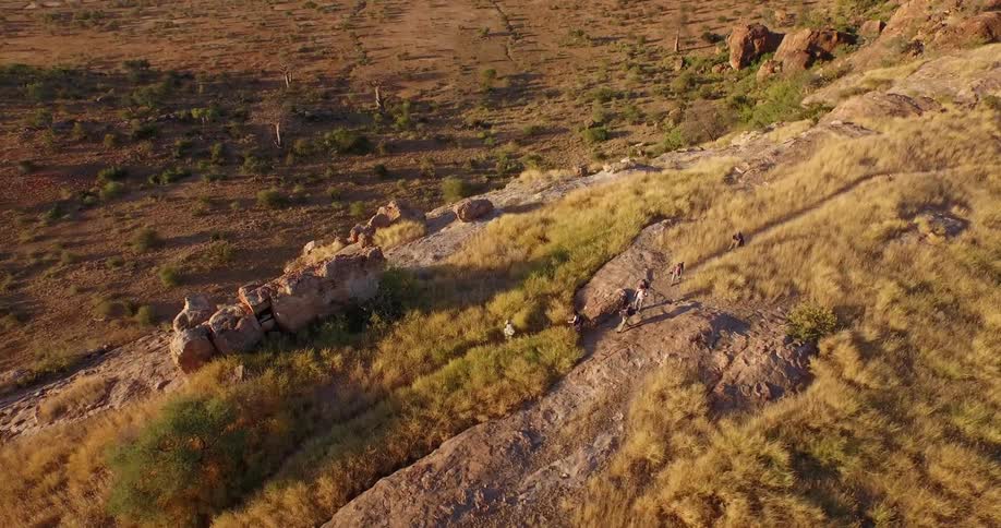 People are hiking on top of a hill