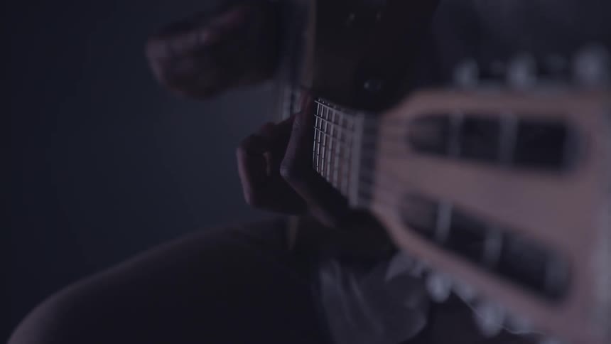 Close-up of someone strumming a guitar
