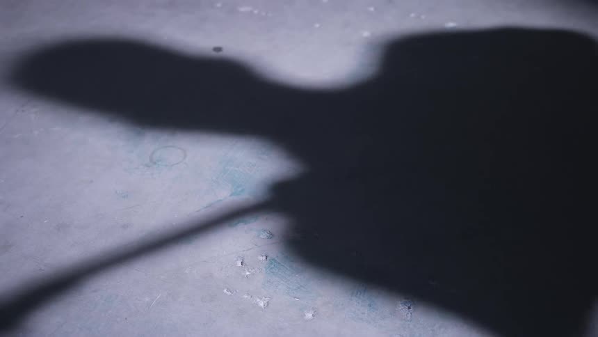 A shadow of a person playing an instrument
