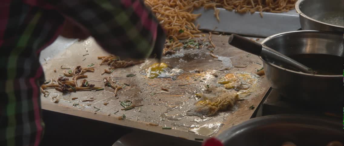 A person is cooking some eggs on a stove