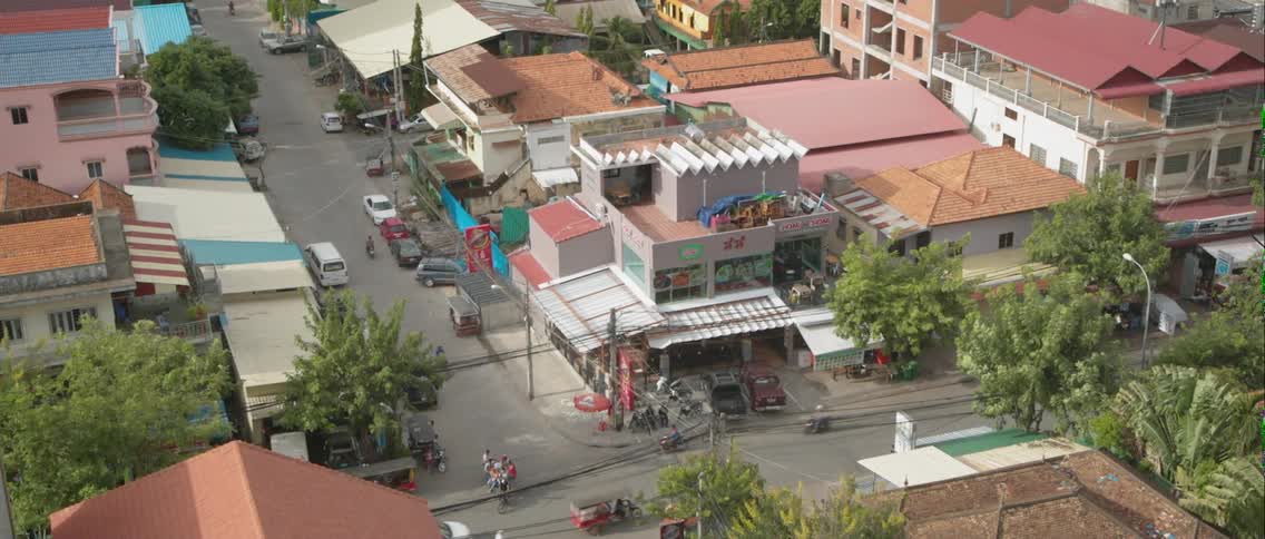 Motorcycles and cars are driven on a city street