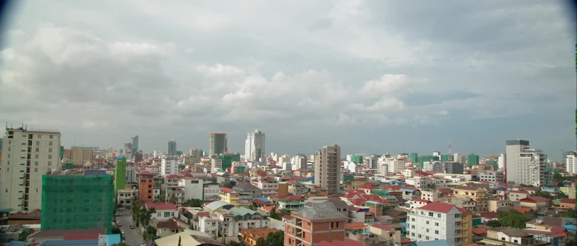 A cloudy sky over a city skyline