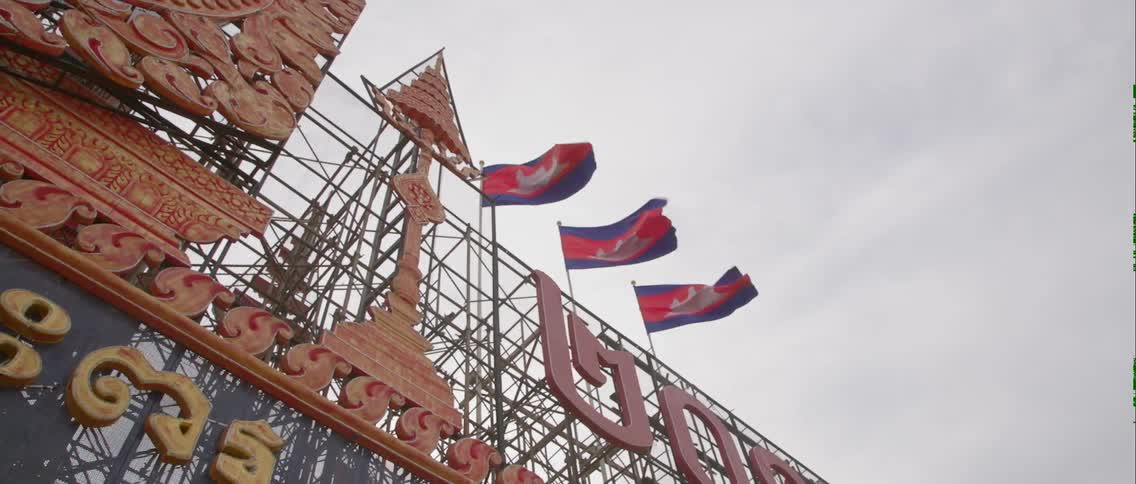 Flags fly in the wind on this building