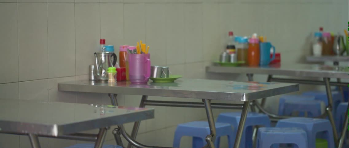 Condiments and utensils on tables in a restaurant