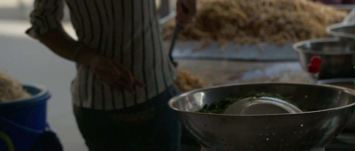 A street side restaurant is preparing food