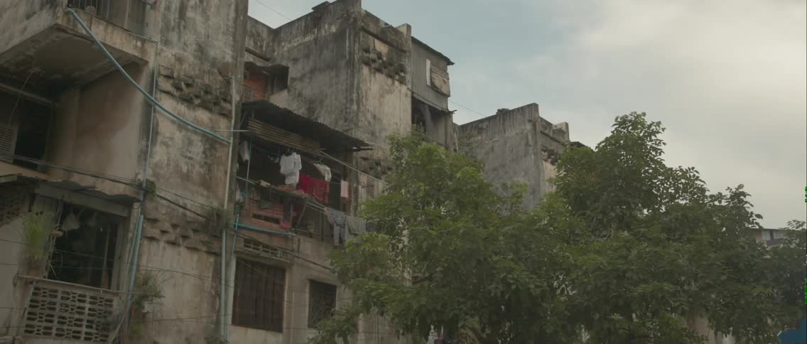 Laundry hangs on the balcony of an old apartment building