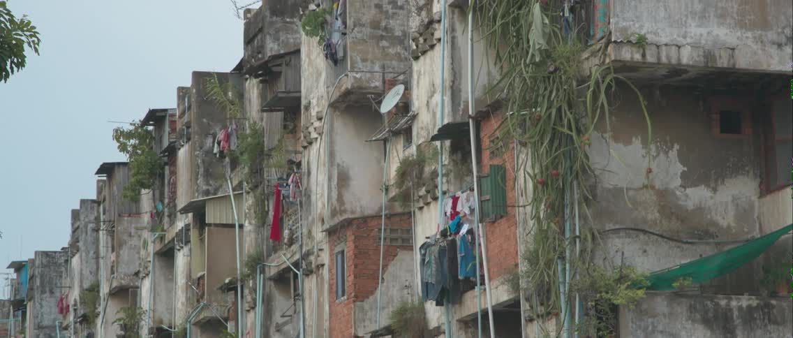 Laundry hangs from the balconies of an old apartment building